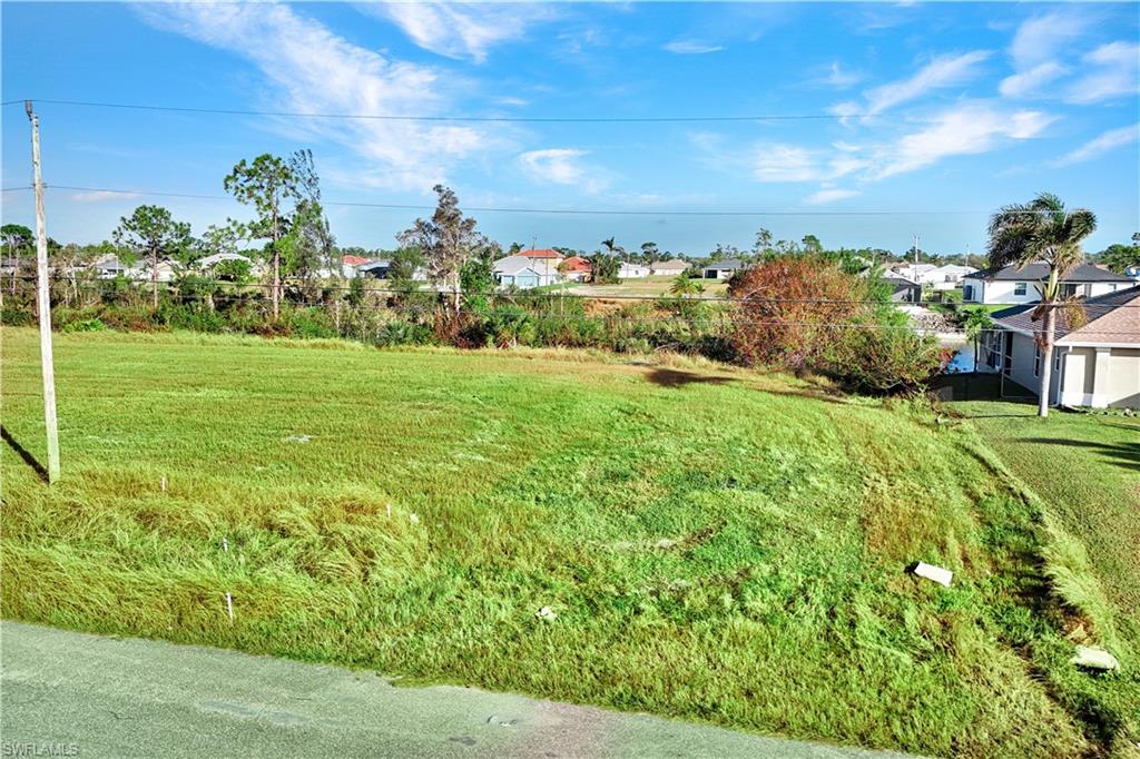 View of green lawn featuring a residential view