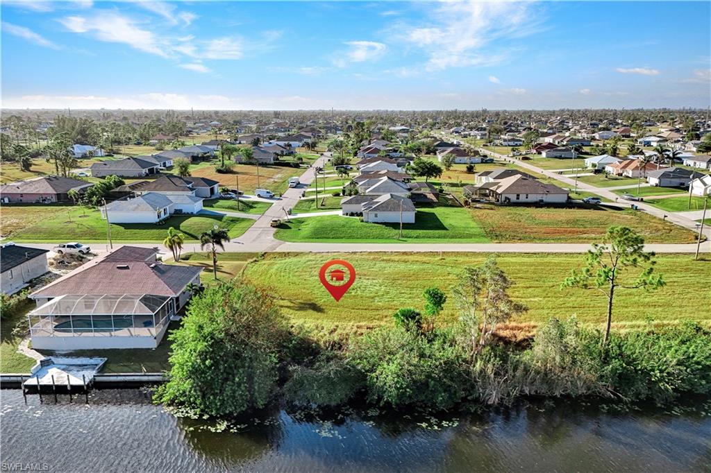 Aerial view of residential area featuring a nearby body of water