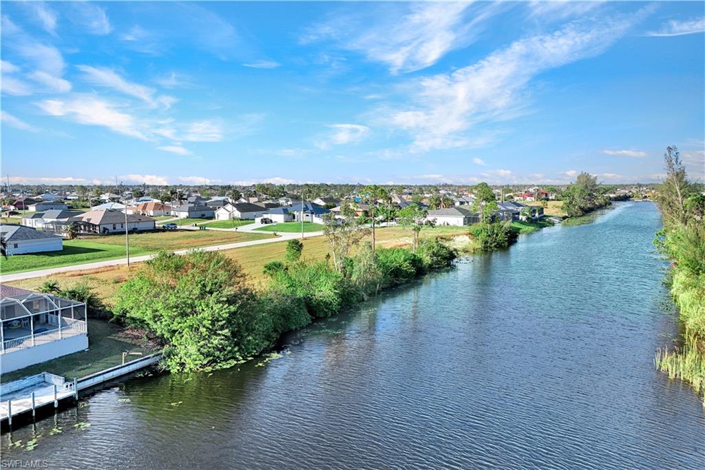 Aerial perspective of suburban area with a nearby body of water