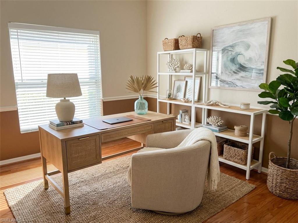 Home office featuring wood finished floors and baseboards