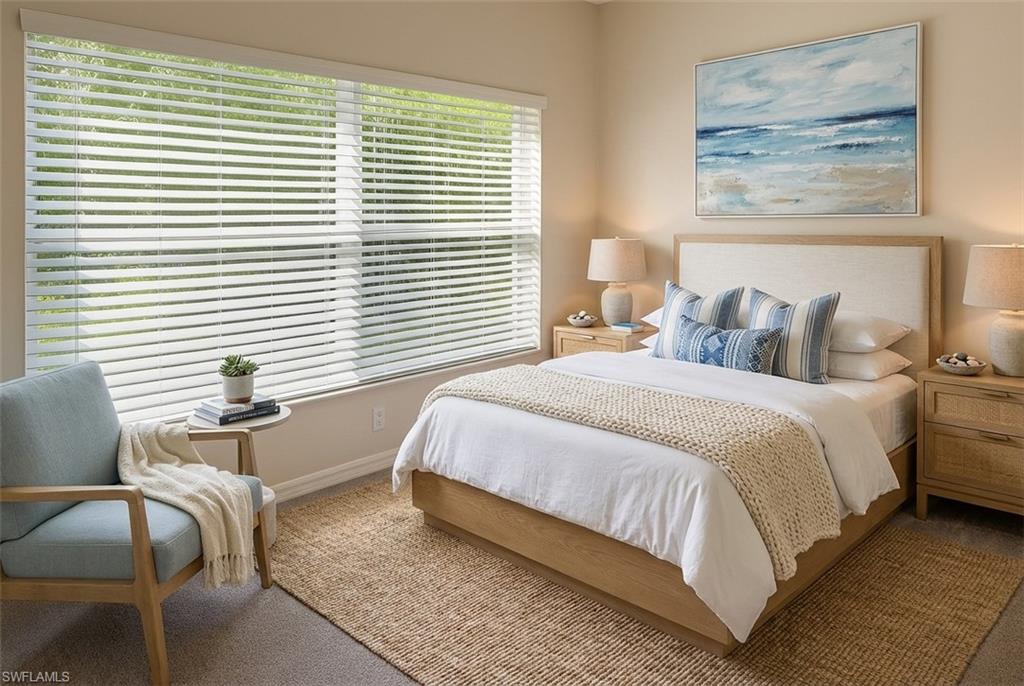 Carpeted bedroom featuring baseboards