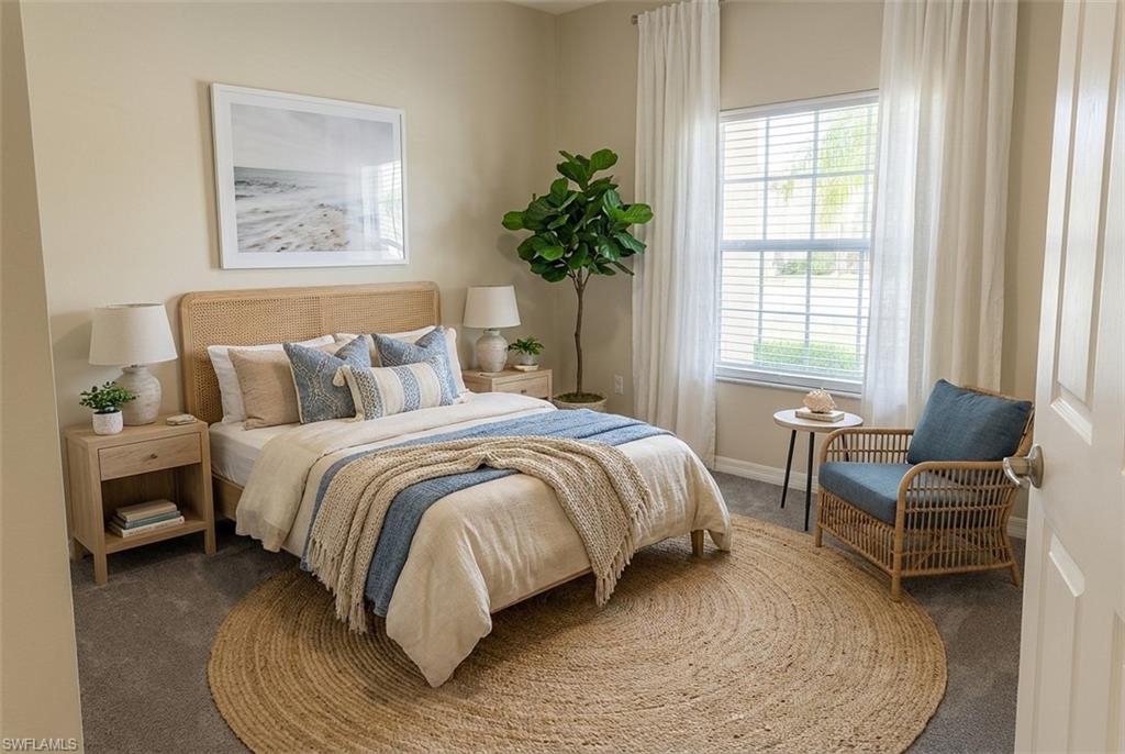 Bedroom featuring carpet flooring and baseboards