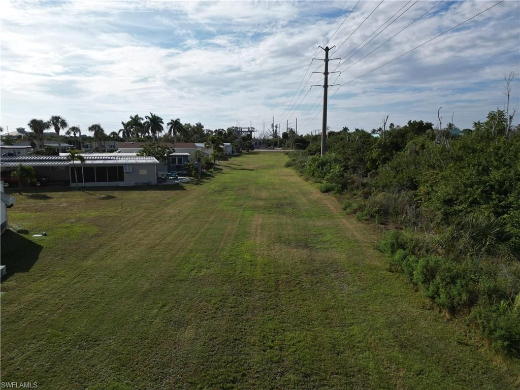 Looking South across the large grassy area to the rear of the lot