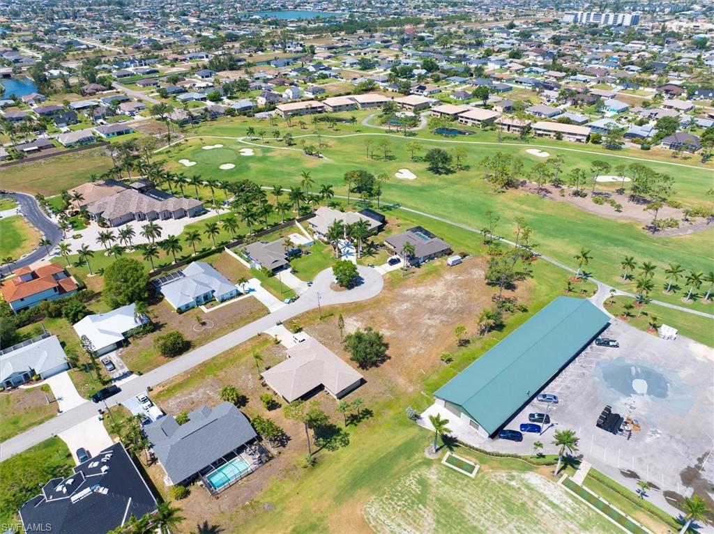 Aerial overview of property's location featuring nearby suburban area and a local golf course
