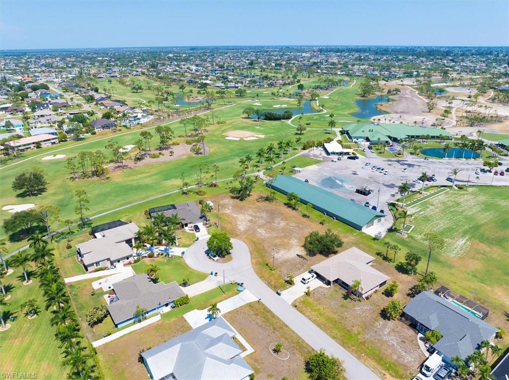 Aerial view of property's location featuring nearby suburban area and a local golf course