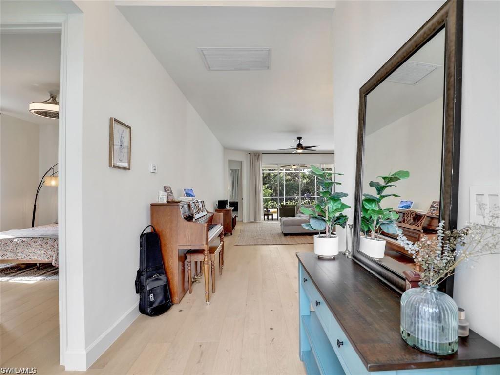 Corridor featuring light wood-style floors and baseboards