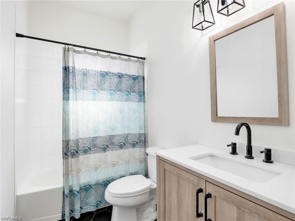 Full bath featuring vanity and shower / bath combo
