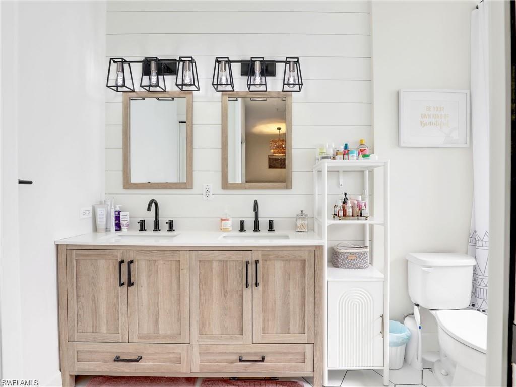 Bathroom with double vanity and toilet
