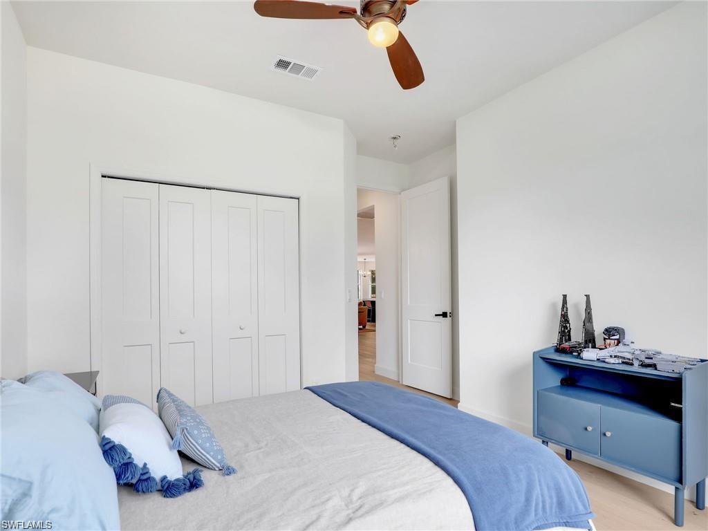 Carpeted bedroom with a closet and ceiling fan