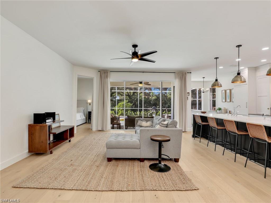 Living room featuring ceiling fan and light wood-style floors