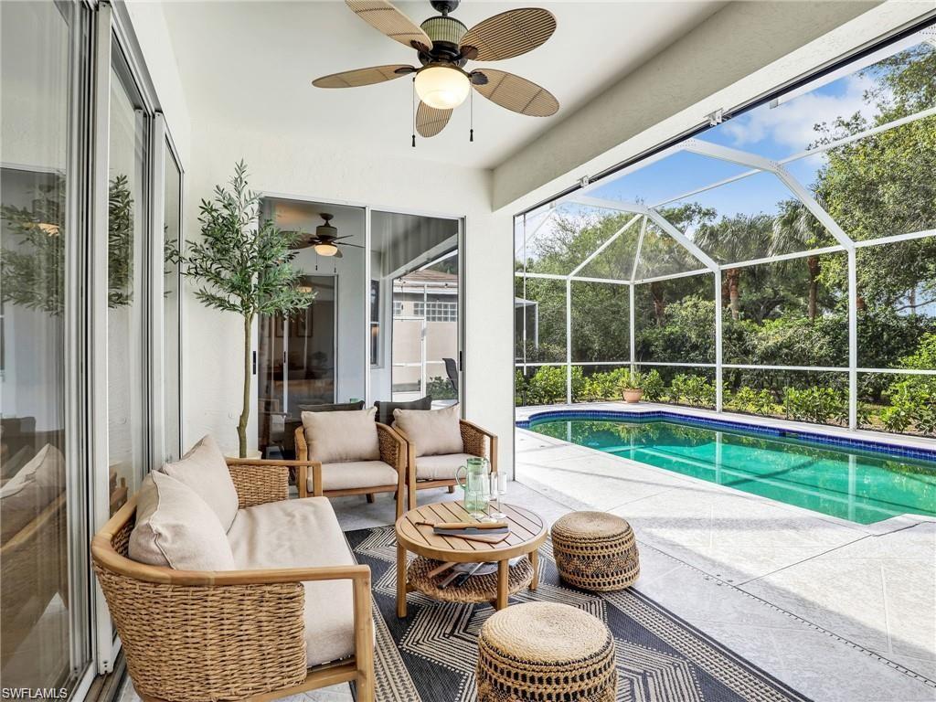 Outdoor pool featuring outdoor lounge area, a sunroom, a patio, and a lanai