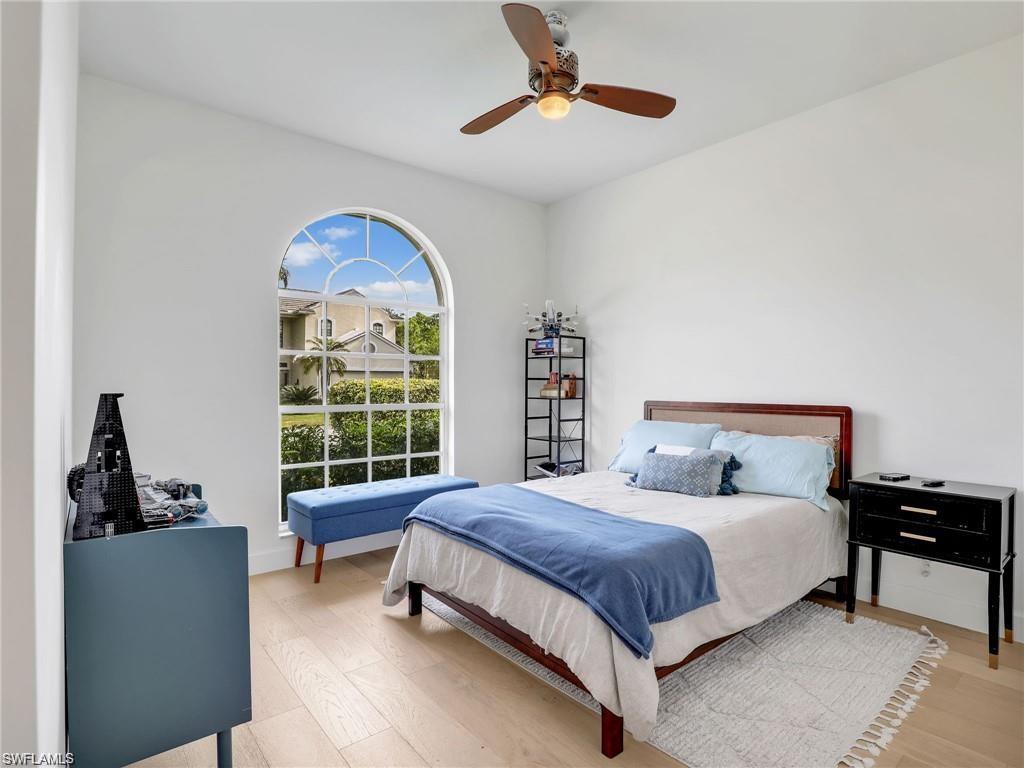 Bedroom with ceiling fan and wood finished floors