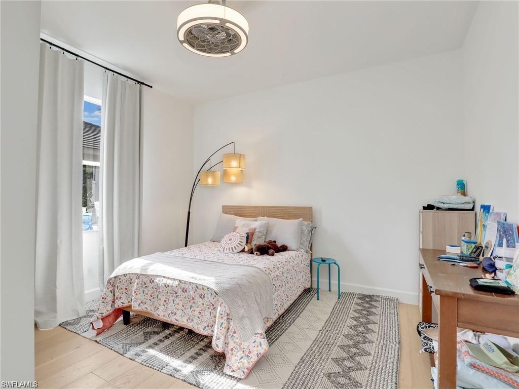 Bedroom featuring light wood-type flooring and baseboards