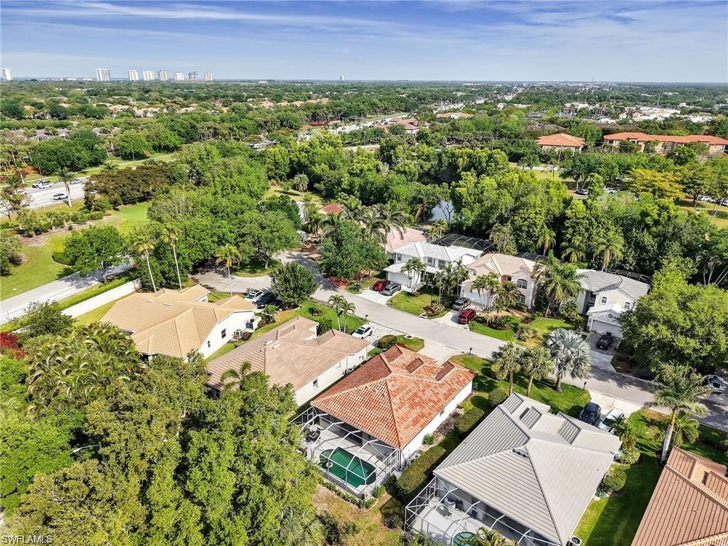 Aerial view of residential area featuring a tree filled landscape