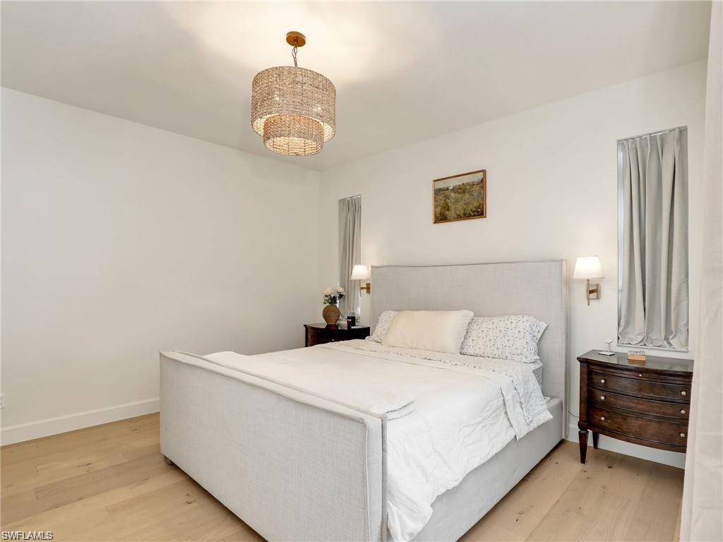 Bedroom featuring light wood-style floors and a chandelier