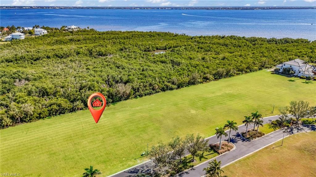 Drone / aerial view of a nearby body of water and a forest