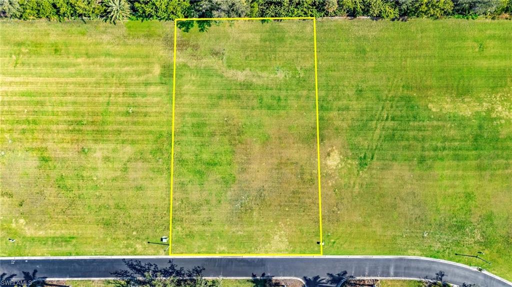 Aerial view of property and surrounding area featuring property parcel outlined