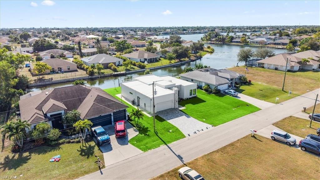 Aerial view of residential area featuring a nearby body of water