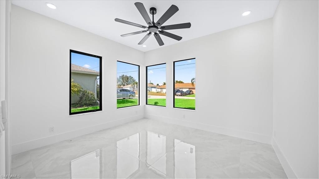 Unfurnished room featuring light marble finish flooring, recessed lighting, and ceiling fan