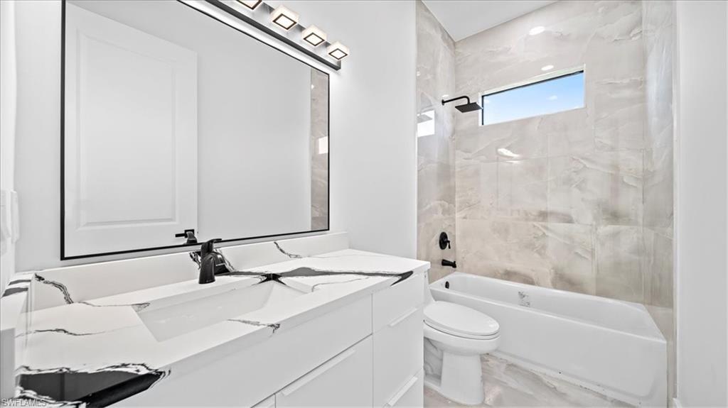 Bathroom featuring washtub / shower combination and vanity