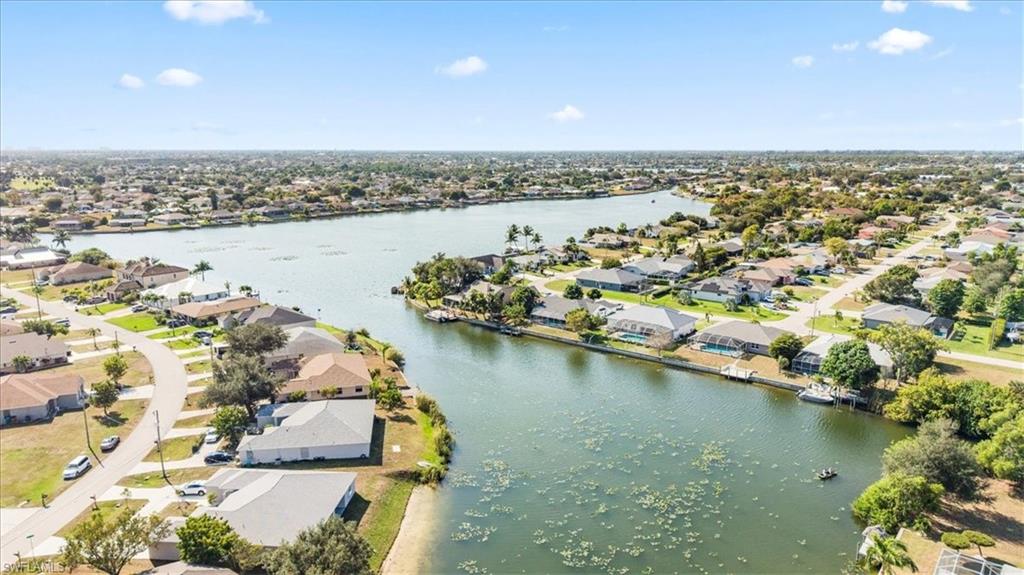 Aerial perspective of suburban area featuring a large body of water