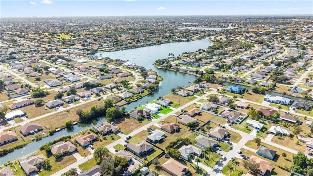 Aerial overview of property's location with nearby suburban area and a nearby body of water