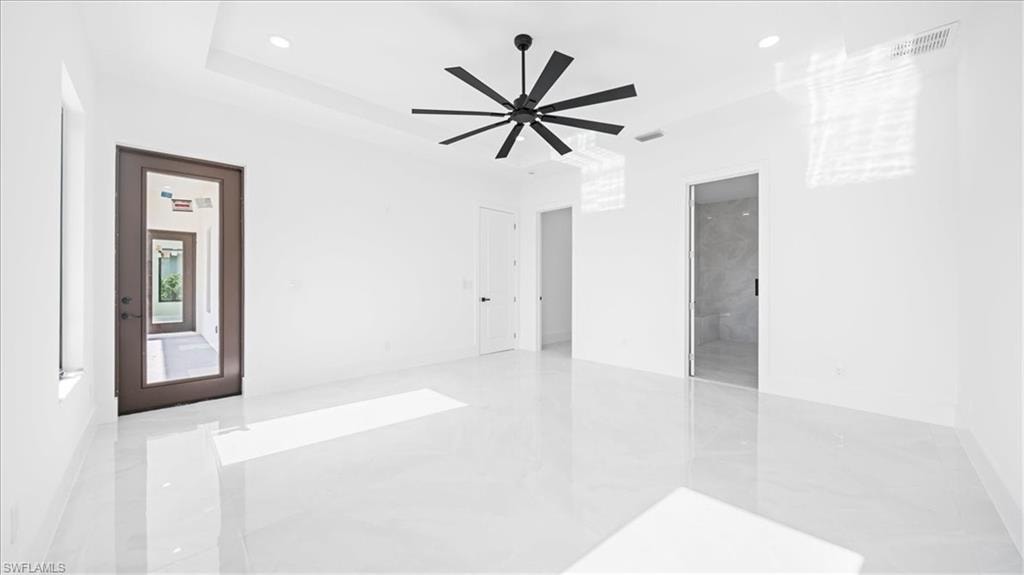 Empty room featuring light marble finish flooring, recessed lighting, and a ceiling fan