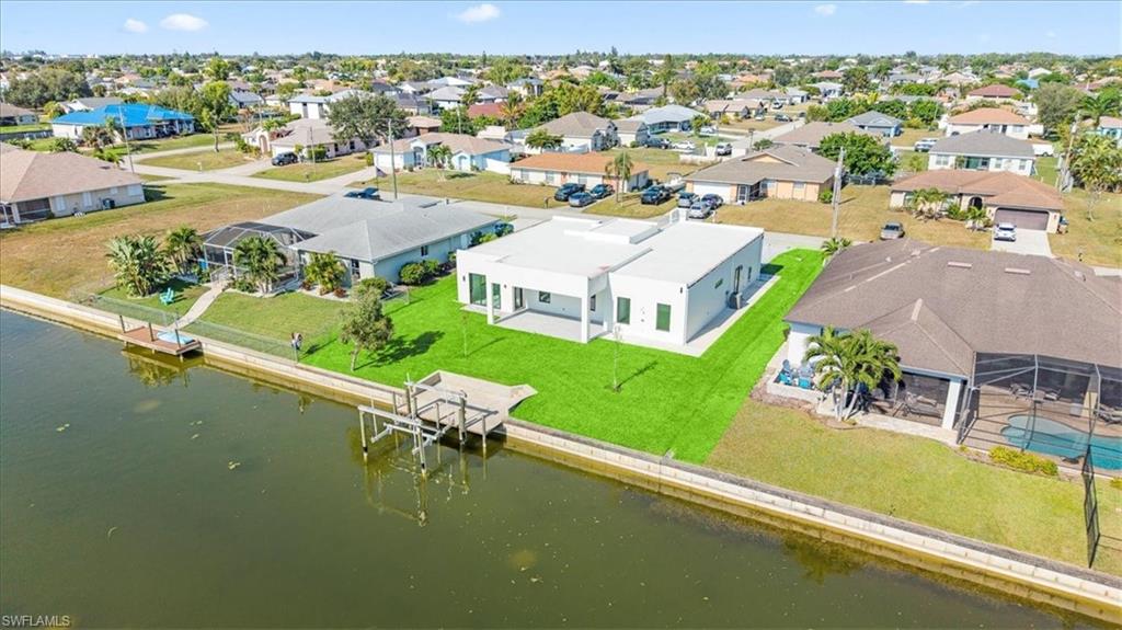 Aerial view of residential area featuring a large body of water