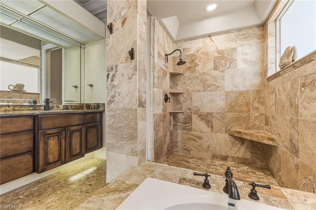 Bathroom featuring vanity and a tile shower