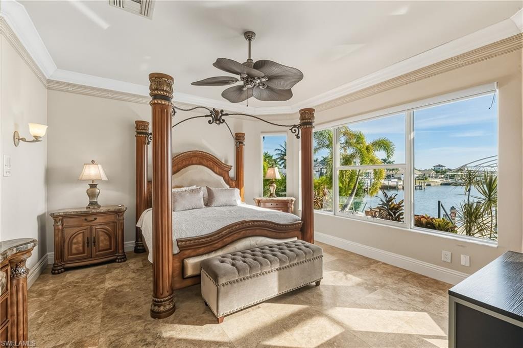 Bedroom with a water view, ornamental molding, and a ceiling fan