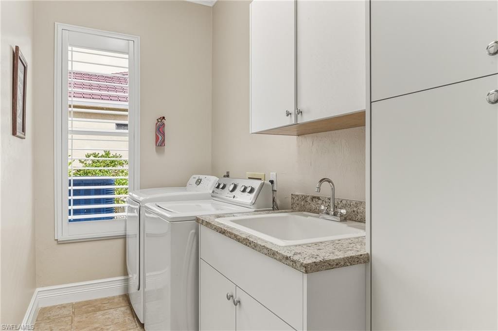 Laundry room with cabinet space and washing machine and dryer