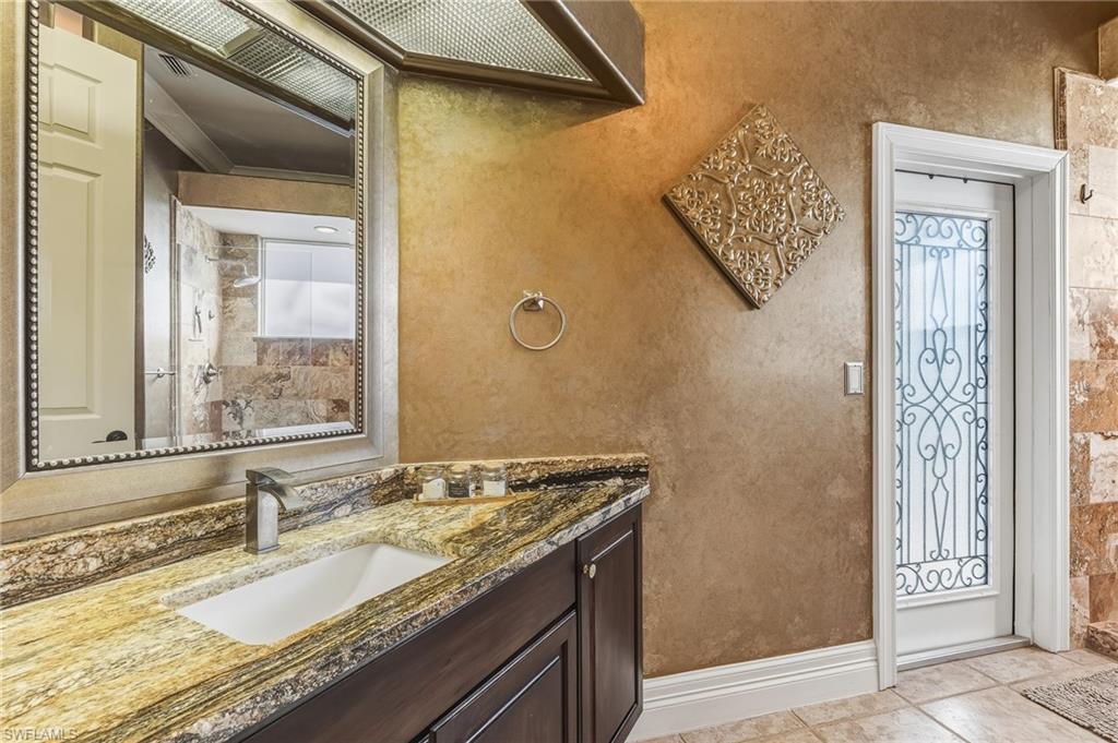 Full bath with vanity and light tile patterned flooring