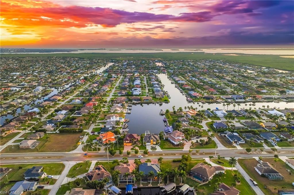 Aerial view at dusk of a water view and a residential view