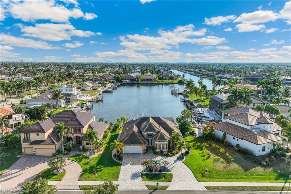 Aerial view of residential area featuring a nearby body of water
