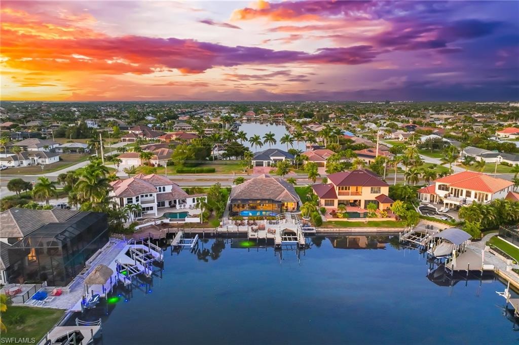Aerial view at dusk of a water view and a residential view