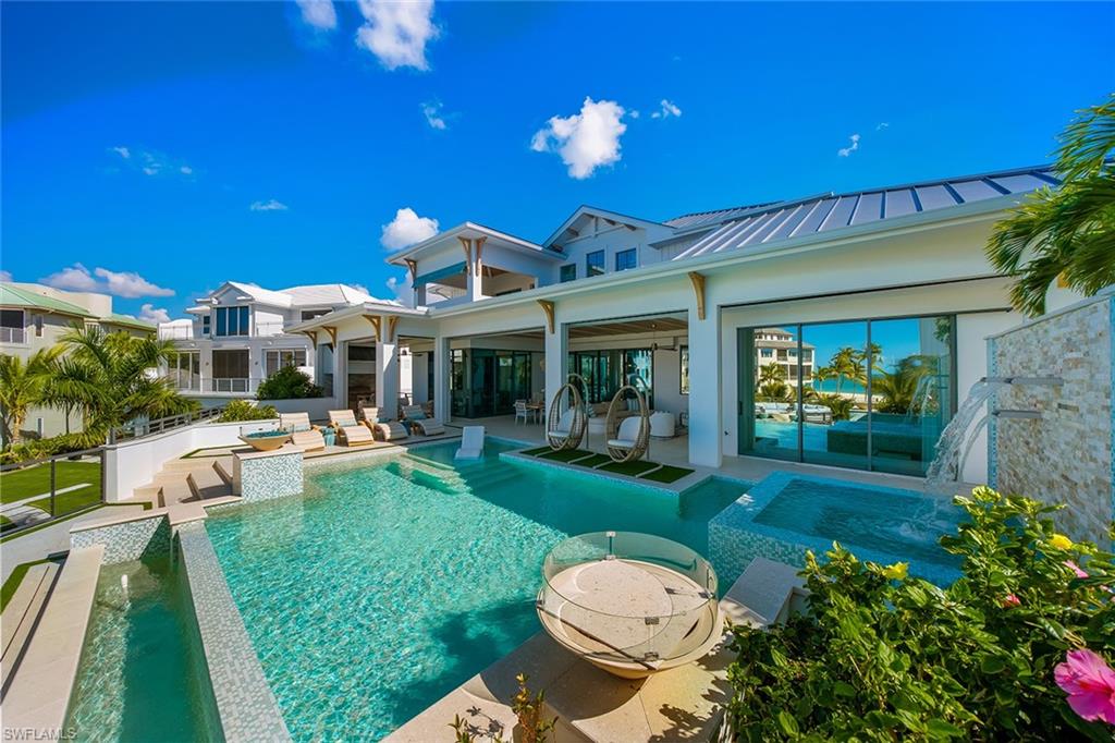 Swimming pool with a patio and an in-ground hot tub