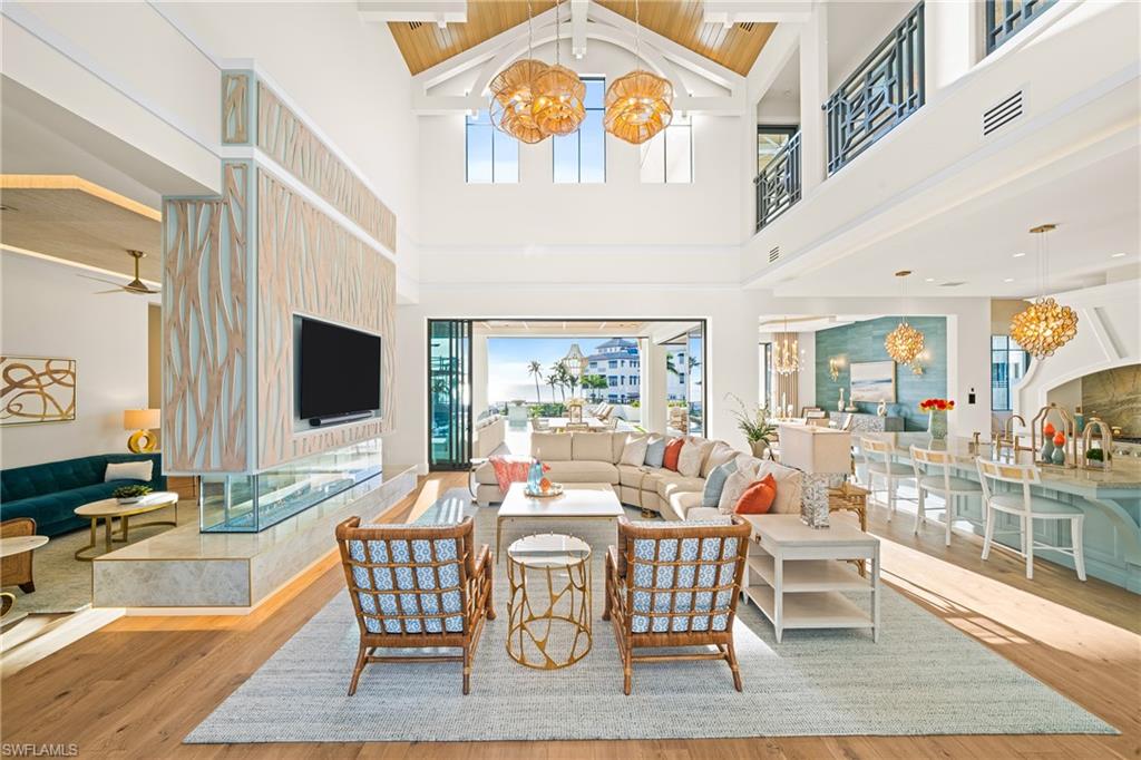 Living area featuring a chandelier, light wood finished floors, healthy amount of natural light, and wooden ceiling