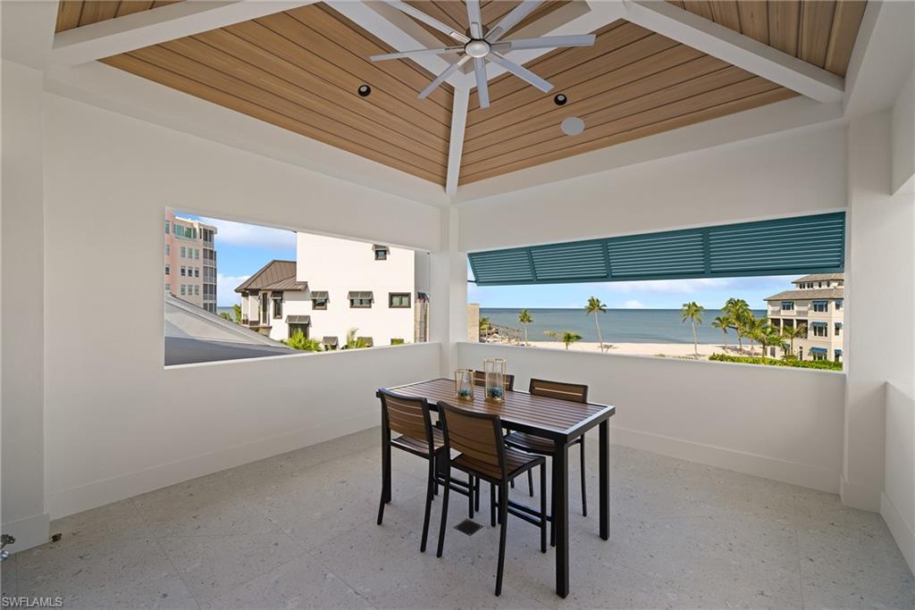 View of patio / terrace featuring outdoor dining area, ceiling fan, and a water view