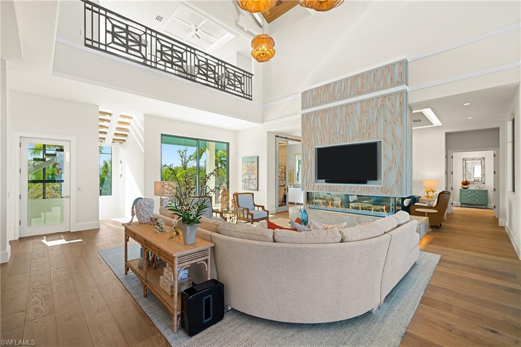 Living room featuring hardwood / wood-style flooring and a high ceiling
