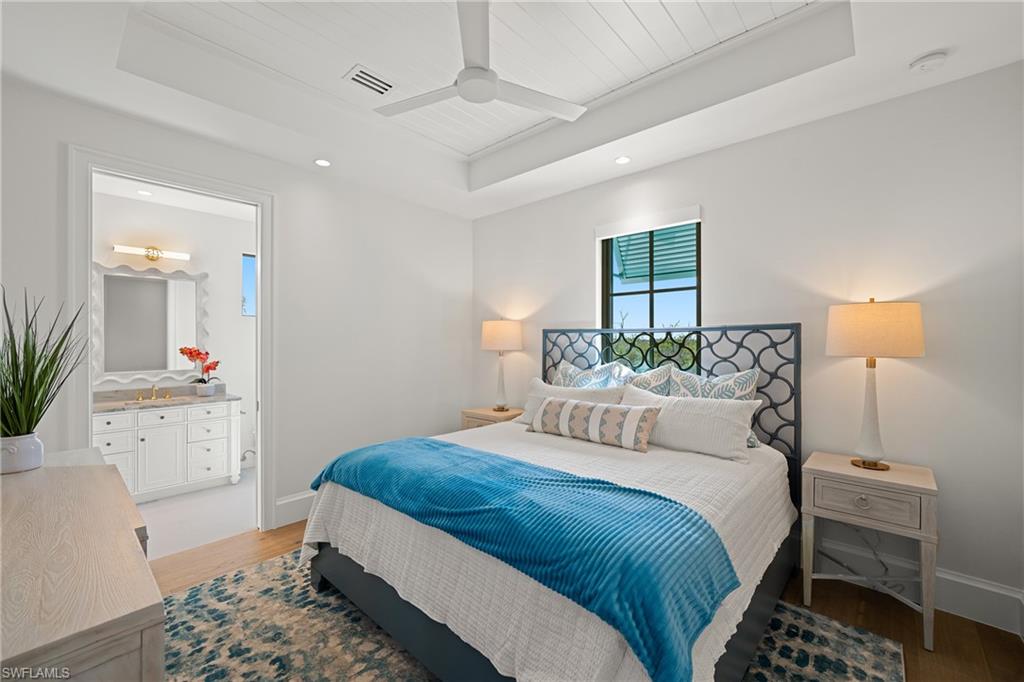 Bedroom with recessed lighting, a ceiling fan, light wood-type flooring, a raised ceiling, and wooden ceiling