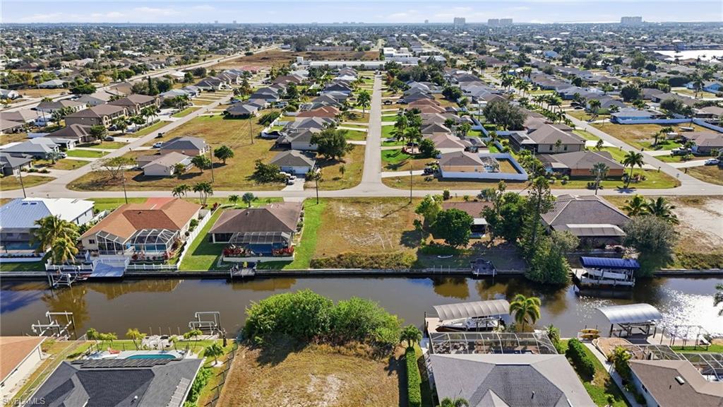 Aerial perspective of suburban area featuring a large body of water