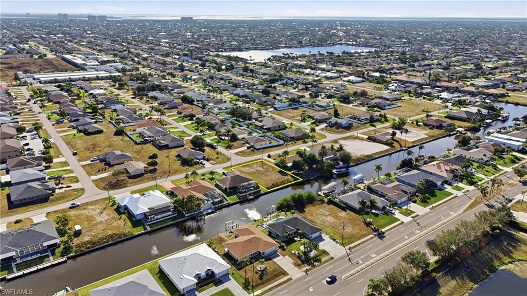 View of property location with a large body of water and nearby suburban area