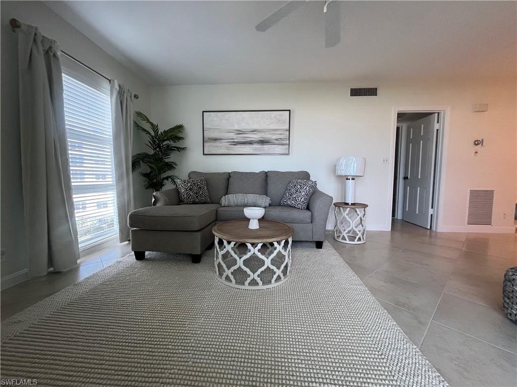 Living room with baseboards and ceiling fan