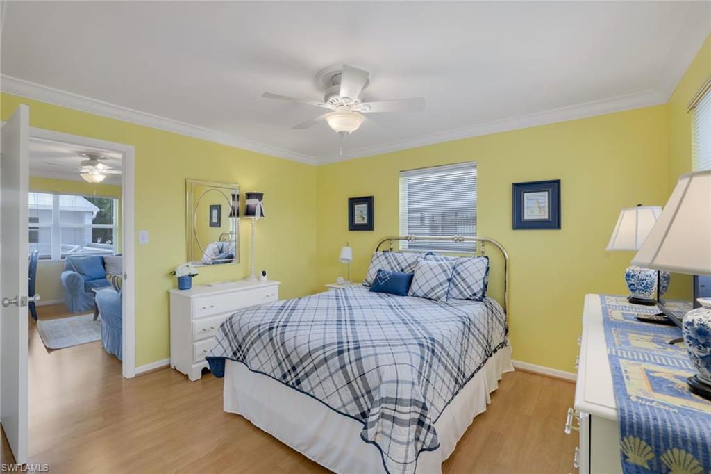 Bedroom featuring multiple windows, light hardwood / wood-style floors, and ceiling fan