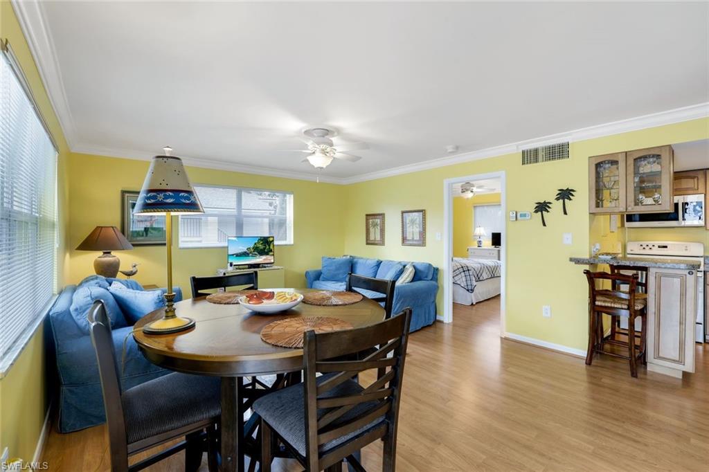 Dining room featuring crown molding, light hardwood / wood-style flooring, and ceiling fan