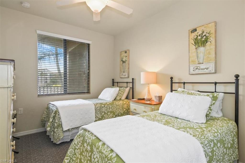 Bedroom with ceiling fan and dark carpet