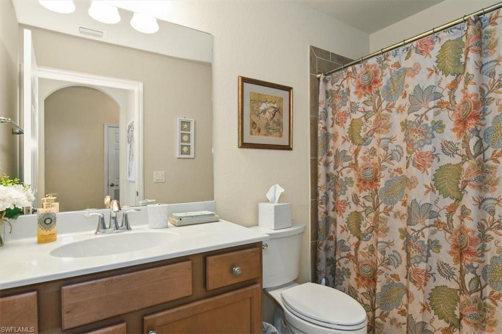 Full bath with vanity and curtained shower