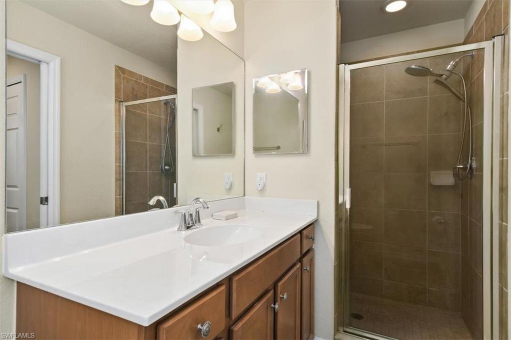 Bathroom with vanity and a stall shower