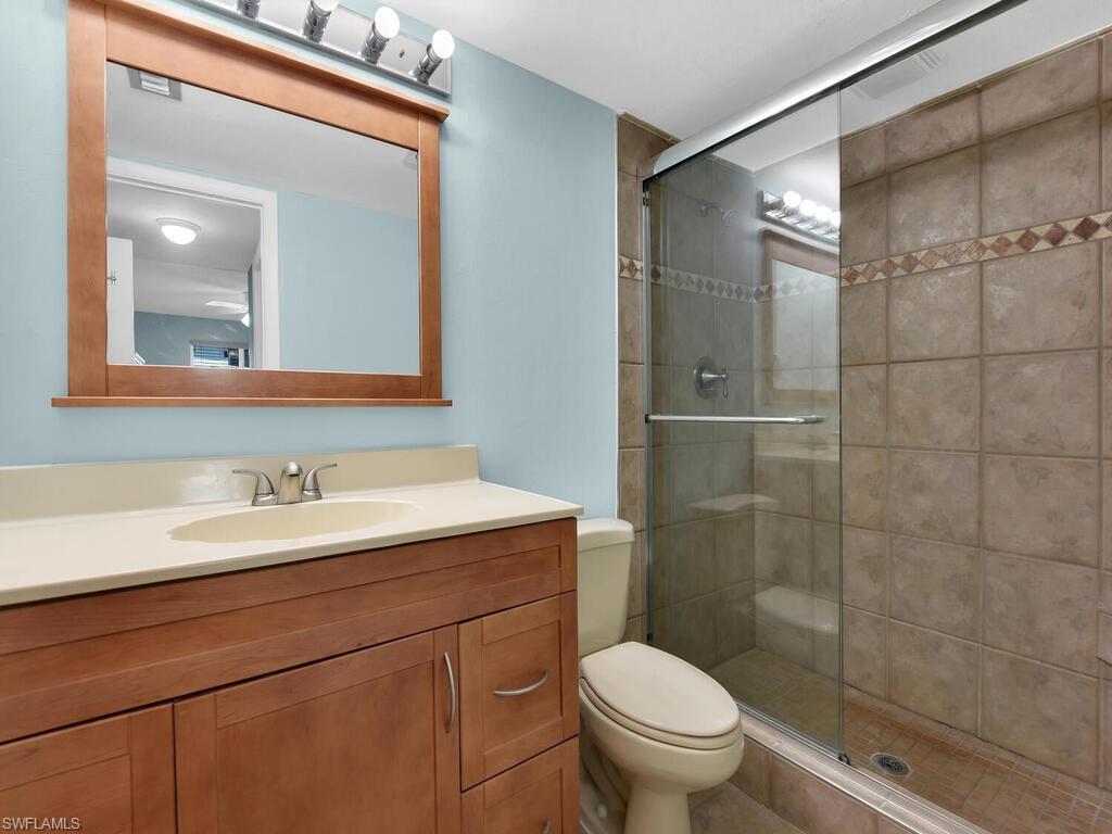 Full bath featuring a shower stall and vanity