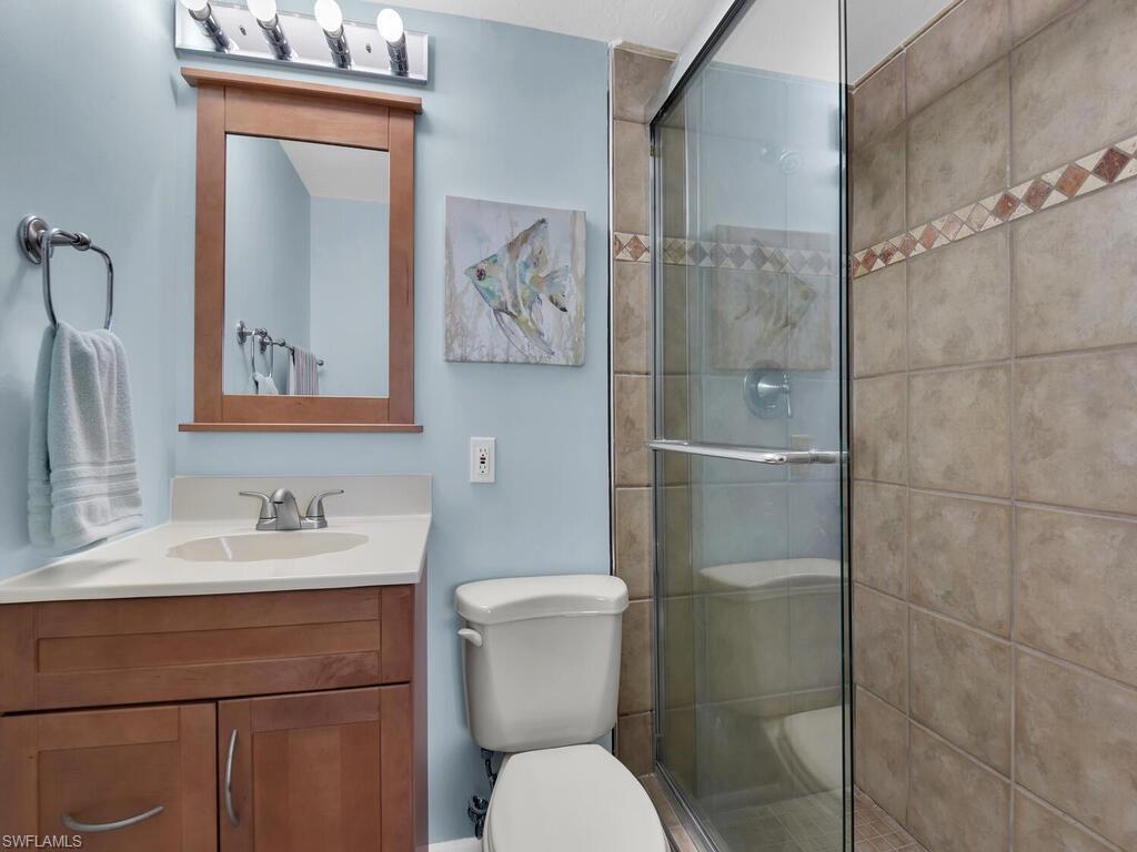 Bathroom featuring a shower stall and vanity